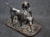 bronze statue of a dog and a cat on a wooden base