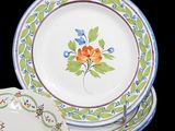 a stack of plates with flowers on them on a black background
