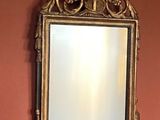 a mirror on the wall above a sink in a bathroom