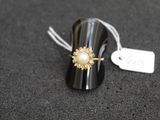 a close up of a ring on a black surface with a price tag