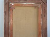 an old picture frame sitting on top of a wooden table