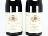 two bottles of wine are sitting next to each other on a white surface