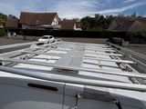 a man that is standing on the roof of a van