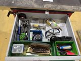 a drawer full of assorted items on a table