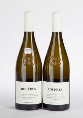 two bottles of white wine sitting next to each other on a white surface