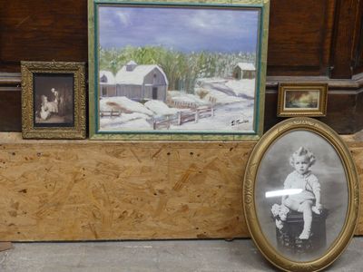 a picture of a woman and a child in front of a picture of a barn