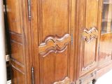 a large wooden cabinet with a mirror on top of it