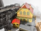 a lot of toy trains on a table with a building