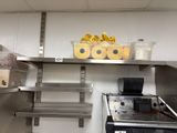 a kitchen with stainless steel shelves and a toaster oven