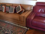 a couch and chair in a living room with a rug