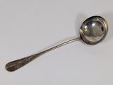 a silver spoon with a spoon handle on a white surface