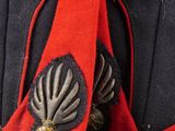 a close up of a red and black uniform on a mannequin