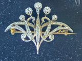 a brooch with a bunch of diamonds on it