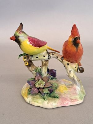 two birds that are sitting on a tree branch