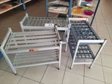 three metal shelves that are on the floor in a store