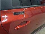 a close up of a car door handle with a sticker on it