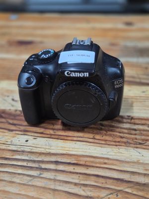 a canon camera sitting on a wooden table