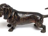 bronze statue of a dachshund dog on a white background
