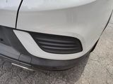 a close up of a car ' s front bumper with a dent on it