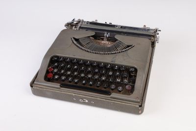 an old typewriter sitting on top of a white surface