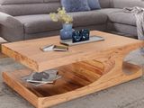 une table basse sur laquelle est posé un magazine, dans un salon