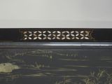a picture of a black and gold painting on the wall