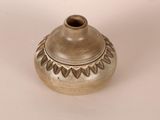 a small brown vase with a decorative design on it
