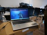 a laptop computer sitting on top of a box in a room
