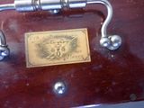 a wooden box with a metal handle and a plaque on it