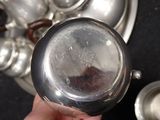 a person holding a silver plate with a silver object in it