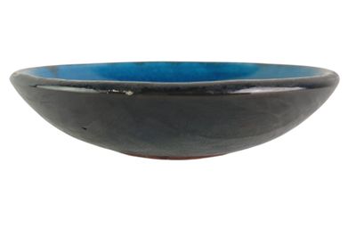 a black and blue bowl sitting on a white surface