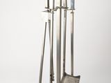 a set of four metal candles and a book on a white background