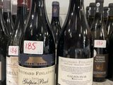 several bottles of wine are lined up on a counter