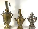 three antique brass urns are sitting next to each other on a white surface