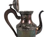 a metal tea pot with a handle on a white background