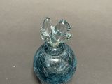 a small glass vase with a bird on it