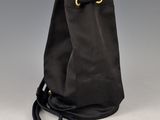 a black bag with a gold ring on the handle