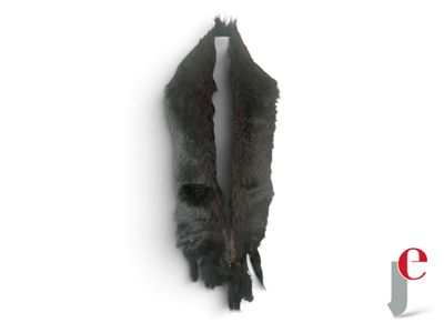 a black fur coat hanging on the wall