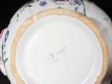 a close up of a plate with a flower design on it