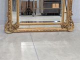 a large mirror sitting on the floor in a room