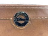 the inside of a brown leather wallet with a horse emblem on it