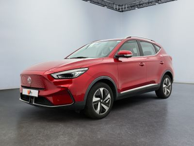 a red suv parked in a large room with a white wall