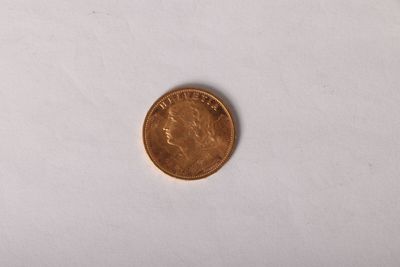 a close up of a penny sitting on a white surface