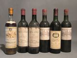 several bottles of wine are lined up on a table