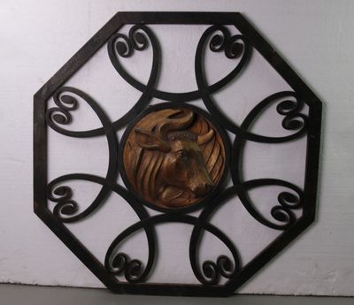 a metal wall decoration with a horse in the center