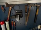 many tools hanging on the wall in the garage