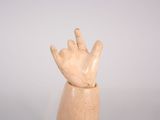 wooden sculpture of a hand with two fingers in the air