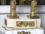 a clock sitting on top of a marble table