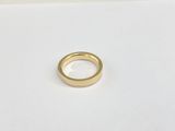 a close up of a gold ring on a white surface