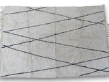 a close up of a white and black rug on a white background
